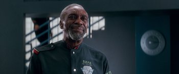 Movie still from “Demolition Man” (1993), directed by Marco Brambilla – An older man wearing a police uniform looking up; Close Up shot, Low angle