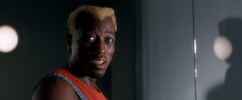 Movie still from “Demolition Man” (1993), directed by Marco Brambilla – A person wearing a red shirt; Close Up shot, Low angle
