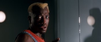 Movie still from “Demolition Man” (1993), directed by Marco Brambilla – A person with a yellow mohawk; Close Up shot, Low angle