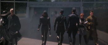 Movie still from “Demolition Man” (1993), directed by Marco Brambilla – A group of people walking down a sidewalk; Wide shot, Low angle