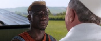 Movie still from “Demolition Man” (1993), directed by Marco Brambilla – A person talking to another person; Close Up shot, Over the shoulder angle