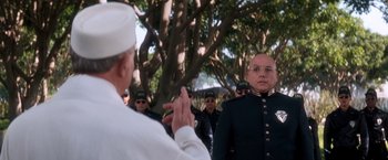 Movie still from “Demolition Man” (1993), directed by Marco Brambilla – A group of men standing next to each other in front of a tree; Close Up shot, Over the shoulder angle