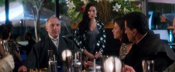 Movie still from “Demolition Man” (1993), directed by Marco Brambilla – A group of people sitting around a table; Medium shot, Over the shoulder angle