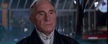 Movie still from “Demolition Man” (1993), directed by Marco Brambilla – An older man wearing a white shirt and a black jacket; Close Up shot, Low angle