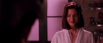 Movie still from “Demolition Man” (1993), directed by Marco Brambilla – A person wearing a white shirt; Close Up shot, Over the shoulder angle