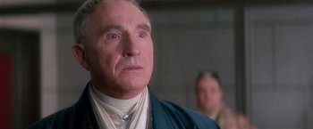 Movie still from “Demolition Man” (1993), directed by Marco Brambilla – An older man looking at something in the distance; Close Up shot, Low angle