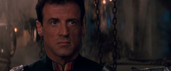Movie still from “Demolition Man” (1993), directed by Marco Brambilla – Sylvester stallone in a scene from the movie ' rocky; Close Up shot, Over the shoulder angle