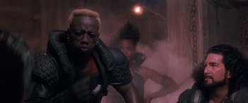 Movie still from “Demolition Man” (1993), directed by Marco Brambilla – A man and a woman are in a room with smoke coming out; Close Up shot, Low angle