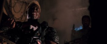 Movie still from “Demolition Man” (1993), directed by Marco Brambilla – A person wearing a helmet; Close Up shot, Low angle