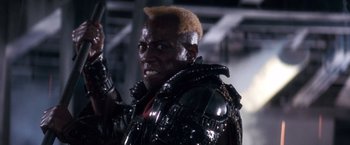Movie still from “Demolition Man” (1993), directed by Marco Brambilla – A person wearing a costume; Close Up shot, Low angle