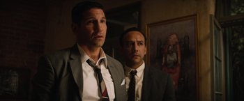 Movie still from “Ford v Ferrari” (2019), directed by James Mangold – A couple of men standing next to each other in a room; Medium shot, Low angle