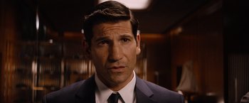 Movie still from “Ford v Ferrari” (2019), directed by James Mangold – A person wearing a suit and tie; Close Up shot, Over the shoulder angle