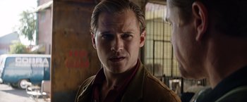 Movie still from “Ford v Ferrari” (2019), directed by James Mangold – A person wearing a suit and tie; Close Up shot, Over the shoulder angle