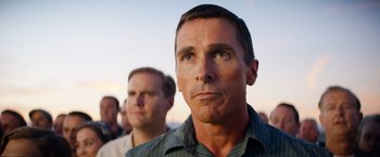 Movie still from “Ford v Ferrari” (2019), directed by James Mangold – A man with a goatee is looking into the distance; Close Up shot, Low angle