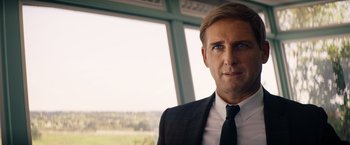 Movie still from “Ford v Ferrari” (2019), directed by James Mangold – A person wearing a suit and tie; Close Up shot, Over the shoulder angle