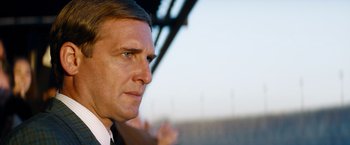 Movie still from “Ford v Ferrari” (2019), directed by James Mangold – A person wearing a suit and tie; Close Up shot, Low angle