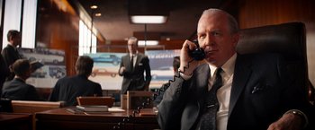 Movie still from “Ford v Ferrari” (2019), directed by James Mangold – An older man is on the phone in an office; Medium shot, Low angle