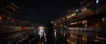 Movie still from “Ford v Ferrari” (2019), directed by James Mangold – A man standing in the middle of the street at night; Extreme Wide shot, Low angle
