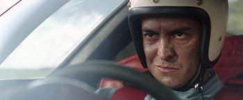 Movie still from “Ford v Ferrari” (2019), directed by James Mangold – A person in a car wearing a helmet; Close Up shot, Low angle