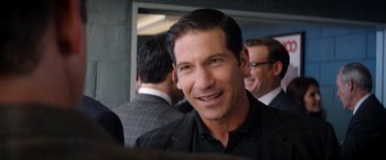 Movie still from “Ford v Ferrari” (2019), directed by James Mangold – A man that is wearing a black shirt; Close Up shot, Over the shoulder angle