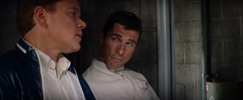 Movie still from “Ford v Ferrari” (2019), directed by James Mangold – A man in a white shirt and a man in a blue tie; Close Up shot, Over the shoulder angle