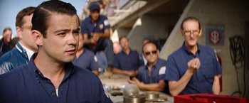 Movie still from “Ford v Ferrari” (2019), directed by James Mangold – A group of men sitting around a table; Close Up shot, Over the shoulder angle