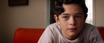 Movie still from “Ford v Ferrari” (2019), directed by James Mangold – A young boy with a white shirt; Close Up shot, Over the shoulder angle