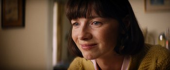 Movie still from “Ford v Ferrari” (2019), directed by James Mangold – A woman's face with a smile on her face; Close Up shot, Over the shoulder angle