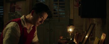 A man sitting in front of a lamp in a room