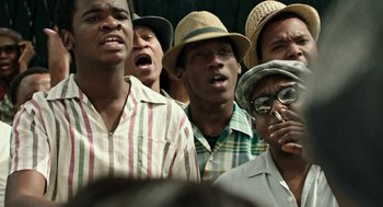 Movie still from “Detroit” (2017), directed by Kathryn Bigelow – A group of men standing next to each other wearing hats; Close Up shot, Low angle