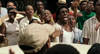 Movie still from “Detroit” (2017), directed by Kathryn Bigelow – A group of people standing next to each other; Medium shot, Low angle
