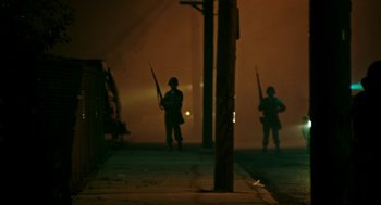 Movie still from “Detroit” (2017), directed by Kathryn Bigelow – A group of men standing next to each other on a street; Wide shot, Low angle