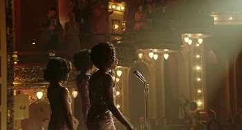 Movie still from “Detroit” (2017), directed by Kathryn Bigelow – A group of women singing in a theater; Extreme Wide shot, Over the shoulder angle