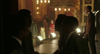 Movie still from “Detroit” (2017), directed by Kathryn Bigelow – A group of men standing in front of a stage; Medium shot, High angle