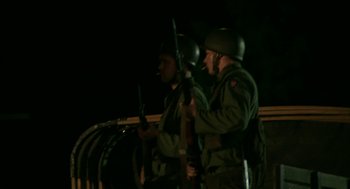 Movie still from “Detroit” (2017), directed by Kathryn Bigelow – Two men in military fatigues are holding guns; Medium shot, Low angle