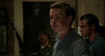 Movie still from “Detroit” (2017), directed by Kathryn Bigelow – A man standing in front of a group of people; Close Up shot, Low angle