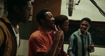 Movie still from “Detroit” (2017), directed by Kathryn Bigelow – A group of men singing in a recording studio; Medium shot, Low angle