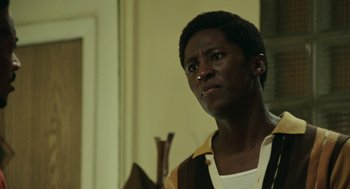 Movie still from “Detroit” (2017), directed by Kathryn Bigelow – A young man looking into the distance in a room; Close Up shot, Low angle