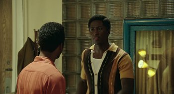Movie still from “Detroit” (2017), directed by Kathryn Bigelow – Two young men standing next to each other in front of a mirror; Medium shot, Over the shoulder angle