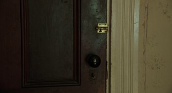 Movie still from “Detroit” (2017), directed by Kathryn Bigelow – The door is open and the lock is on the handle; Extreme Close Up shot, High angle