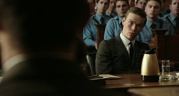 Movie still from “Detroit” (2017), directed by Kathryn Bigelow – A group of people sitting in a room; Medium shot, Over the shoulder angle