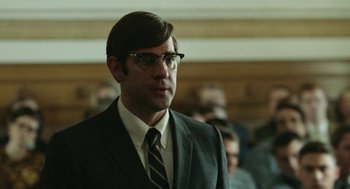 Movie still from “Detroit” (2017), directed by Kathryn Bigelow – A man in a suit and tie standing in front of a group of people; Close Up shot, Low angle