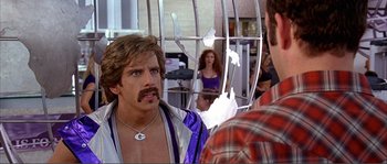 Movie still from “Dodgeball: A True Underdog Story” (2004), directed by Rawson Marshall Thurber – A man with a beard and mustache is talking to another man; Close Up shot, Over the shoulder angle