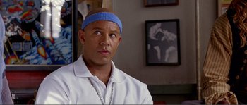 Movie still from “Dodgeball: A True Underdog Story” (2004), directed by Rawson Marshall Thurber – A bald man with a blue head band is looking to his left; Close Up shot, Low angle