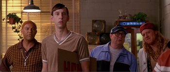 Movie still from “Dodgeball: A True Underdog Story” (2004), directed by Rawson Marshall Thurber – A man standing next to another man in a room; Medium shot, Over the shoulder angle