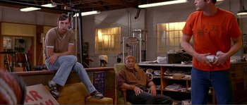 Movie still from “Dodgeball: A True Underdog Story” (2004), directed by Rawson Marshall Thurber – A man sitting in a chair in a room; Wide shot, Low angle