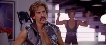 Movie still from “Dodgeball: A True Underdog Story” (2004), directed by Rawson Marshall Thurber – A man in a leather vest and a man in a black tank top; Close Up shot, Low angle