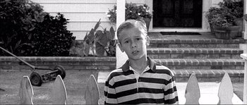 Movie still from “Dodgeball: A True Underdog Story” (2004), directed by Rawson Marshall Thurber – Black and white photograph of a boy in striped shirt; Medium shot, Low angle