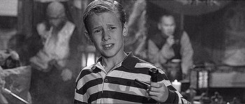 Movie still from “Dodgeball: A True Underdog Story” (2004), directed by Rawson Marshall Thurber – Black and white photograph of a young boy in a striped shirt; Close Up shot, High angle