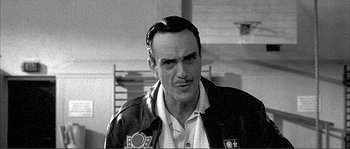 Movie still from “Dodgeball: A True Underdog Story” (2004), directed by Rawson Marshall Thurber – Black and white photograph of a man in a leather jacket; Close Up shot, Low angle